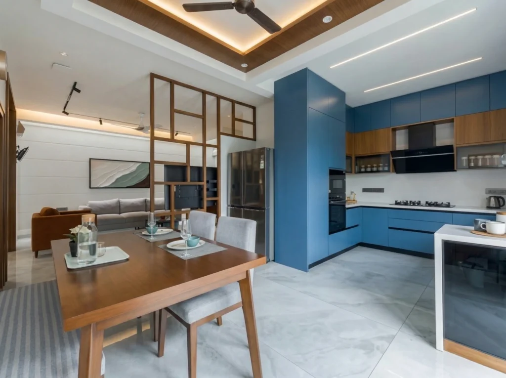 Open-plan dining and kitchen area separated by a designer wooden lattice partition with premium marble-finish vitrified flooring.
