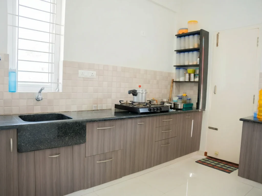 Functional modular kitchen design featuring a custom granite sink, wood-finish cabinetry, and efficient open shelving for a modern residential interior.