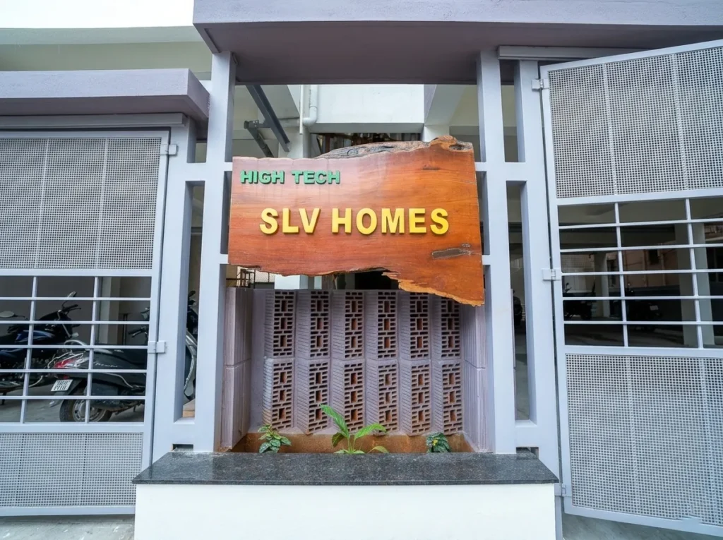 High Tech SLV Homes wooden nameboard at the entrance of a residential building project.