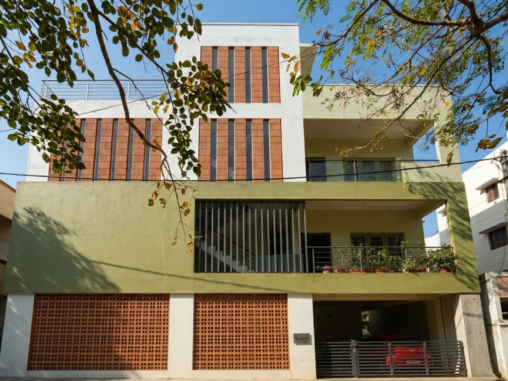 Three-story residential building elevation featuring a unique terracotta vertical clay block facade, olive green accents, and modern glass railings.