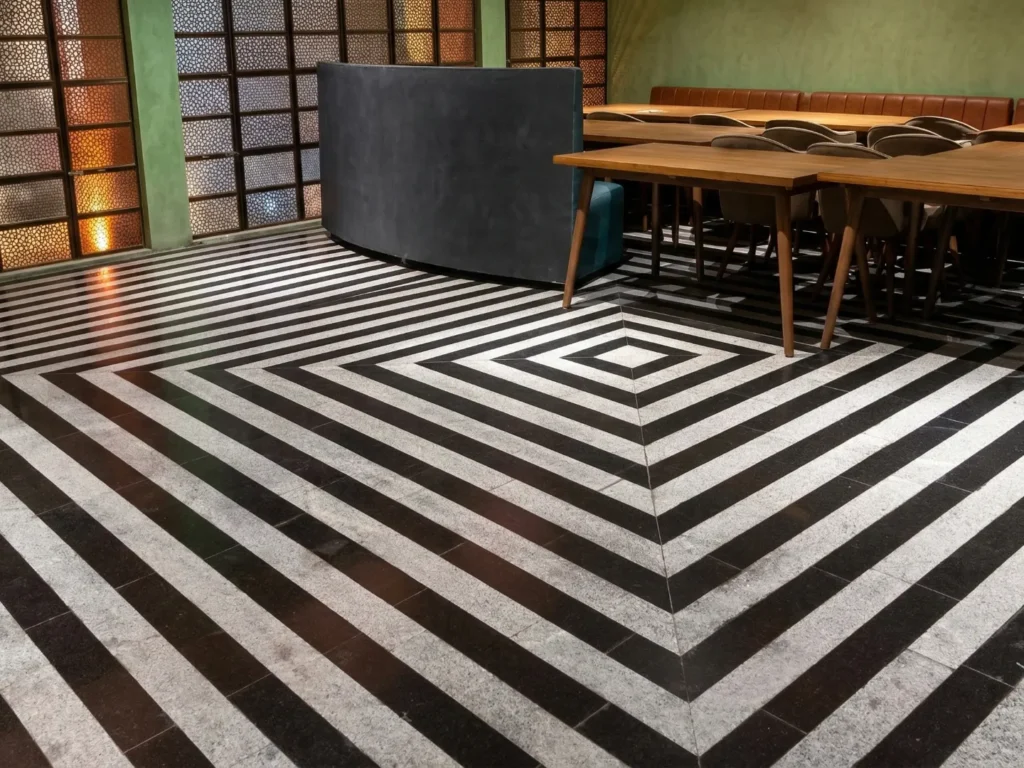 Bold geometric black and white stone floor in a Bangalore restaurant interior construction project by High Tech Constructions