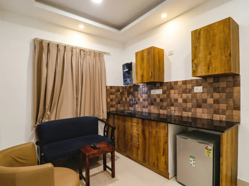 Studio apartment with kitchenette and lounge area, showcasing residential construction excellence.