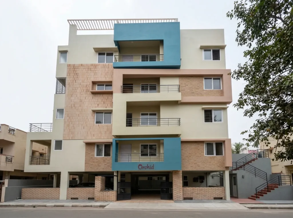 Orchid multi-storey residential building with exposed brick cladding, teal accent panels, and stilt parking in Bangalore.